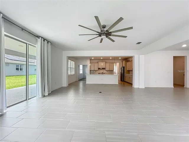 a view of a livingroom with a ceiling fan and window