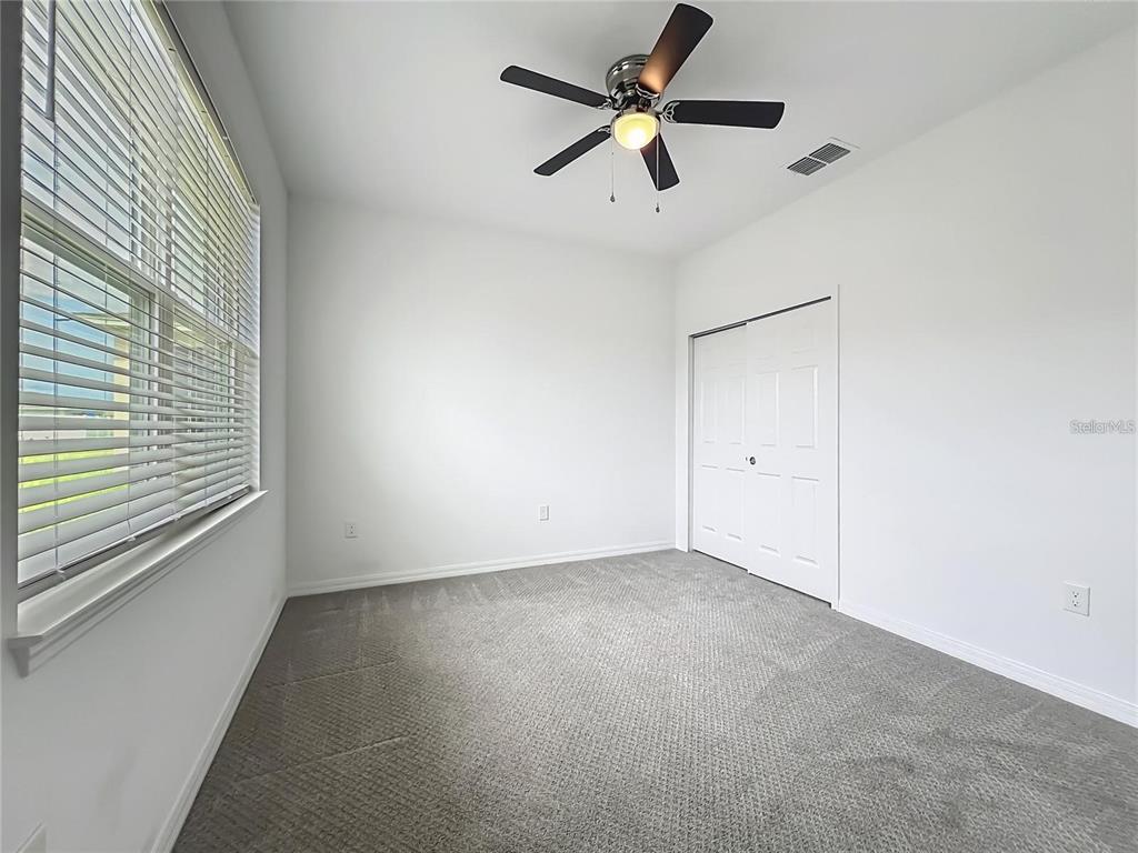 7483 Southwest 64th St Road Ocala, FL 34474 - Photo 22 of 74 an empty room with a window and a fan
