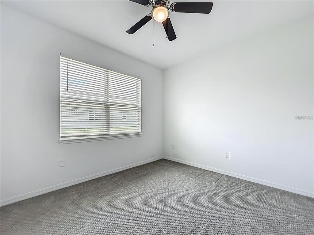 7483 Southwest 64th St Road Ocala, FL 34474 - Photo 23 of 74 a view of room with ceiling fan and window