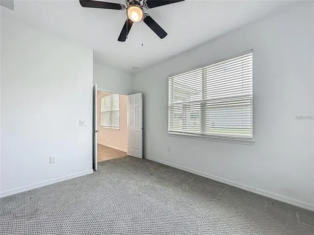 a view of staircase with white walls and a window