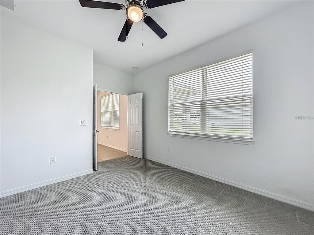 7483 Southwest 64th St Road Ocala, FL 34474 - Photo 24 of 74 an empty room with windows and fan