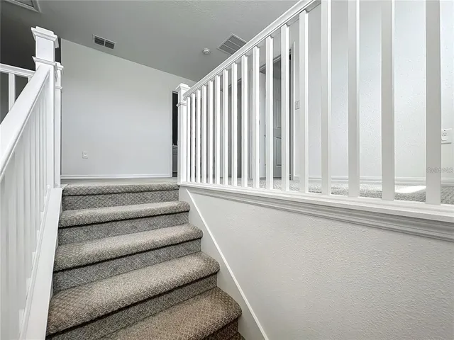 an empty room with closet and ceiling fan
