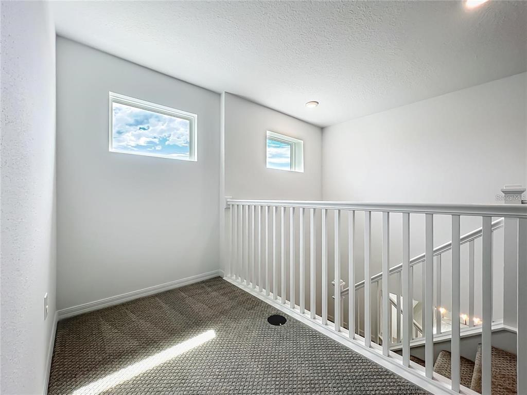 7483 Southwest 64th St Road Ocala, FL 34474 - Photo 31 of 74 a view of an empty room with wooden floor