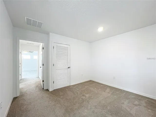 a spacious bathroom with a double vanity sink and mirror