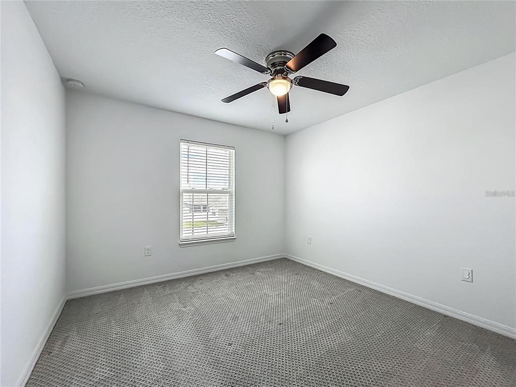 7483 Southwest 64th St Road Ocala, FL 34474 - Photo 36 of 74 an empty room with a window and a fan