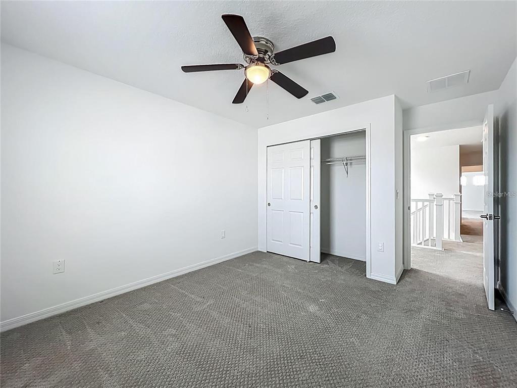 7483 Southwest 64th St Road Ocala, FL 34474 - Photo 37 of 74 an empty room with closet and ceiling fan