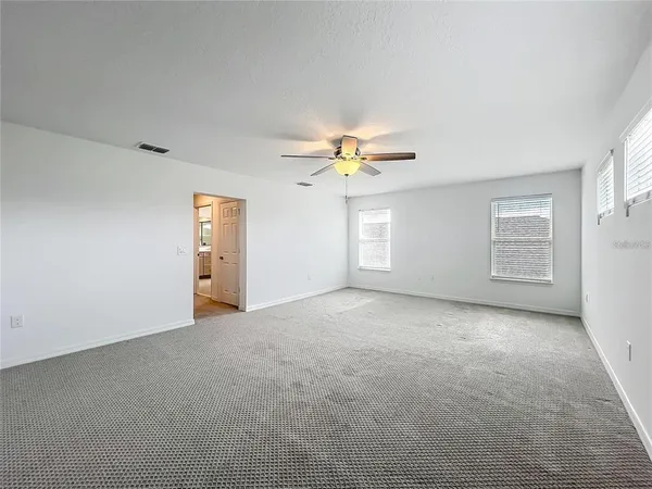 a bathroom with a granite countertop toilet a sink and a bathtub