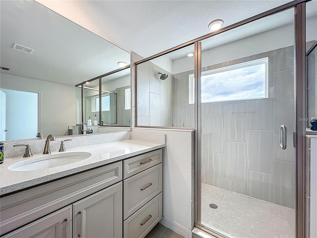 7483 Southwest 64th St Road Ocala, FL 34474 - Photo 42 of 74 a bathroom with a granite countertop sink mirror and double
