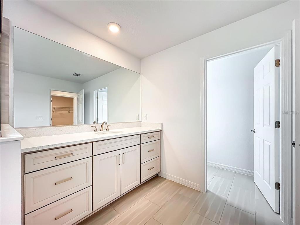 7483 Southwest 64th St Road Ocala, FL 34474 - Photo 43 of 74 a spacious bathroom with a double vanity sink and mirror