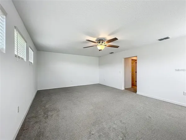 a front view of a house with a garden and yard