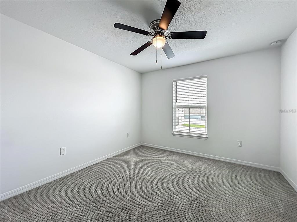 7483 Southwest 64th St Road Ocala, FL 34474 - Photo 46 of 74 an empty room with a ceiling fan and windows