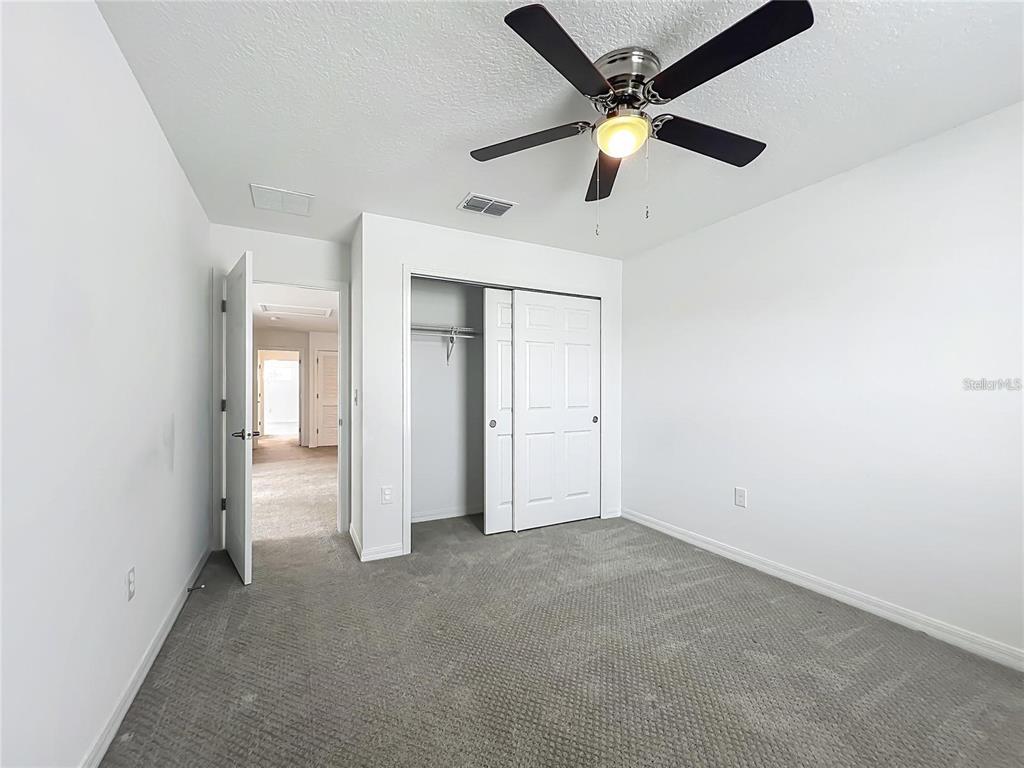 7483 Southwest 64th St Road Ocala, FL 34474 - Photo 47 of 74 an empty room with closet and a ceiling fan
