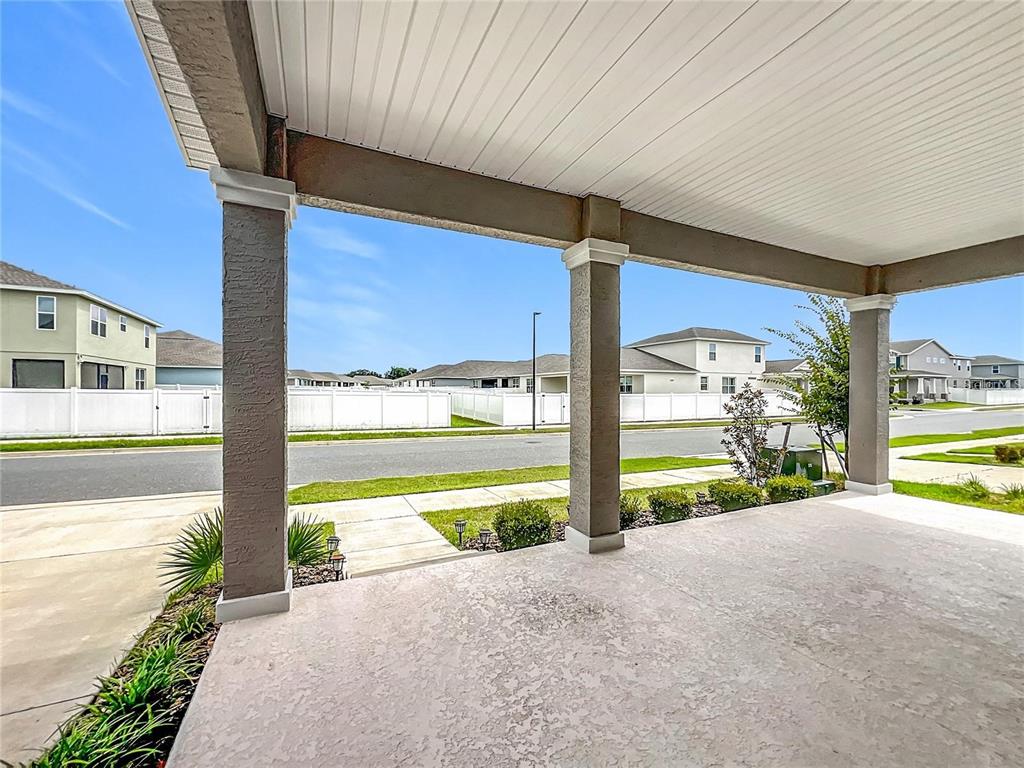7483 Southwest 64th St Road Ocala, FL 34474 - Photo 5 of 74 a view of a building with a floor to ceiling window next to a yard