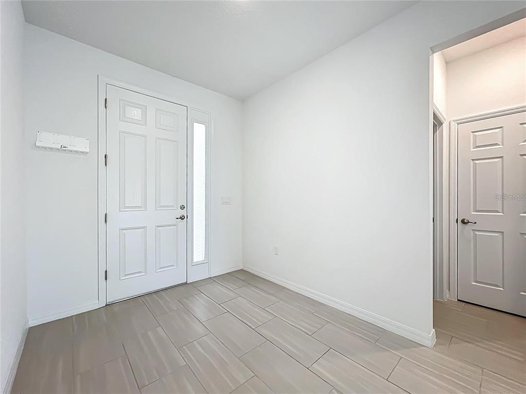 7483 Southwest 64th St Road Ocala, FL 34474 - Photo 6 of 74 an empty room with wooden floor