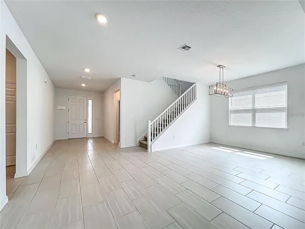 a view of a livingroom with wooden floor and a ceiling fan