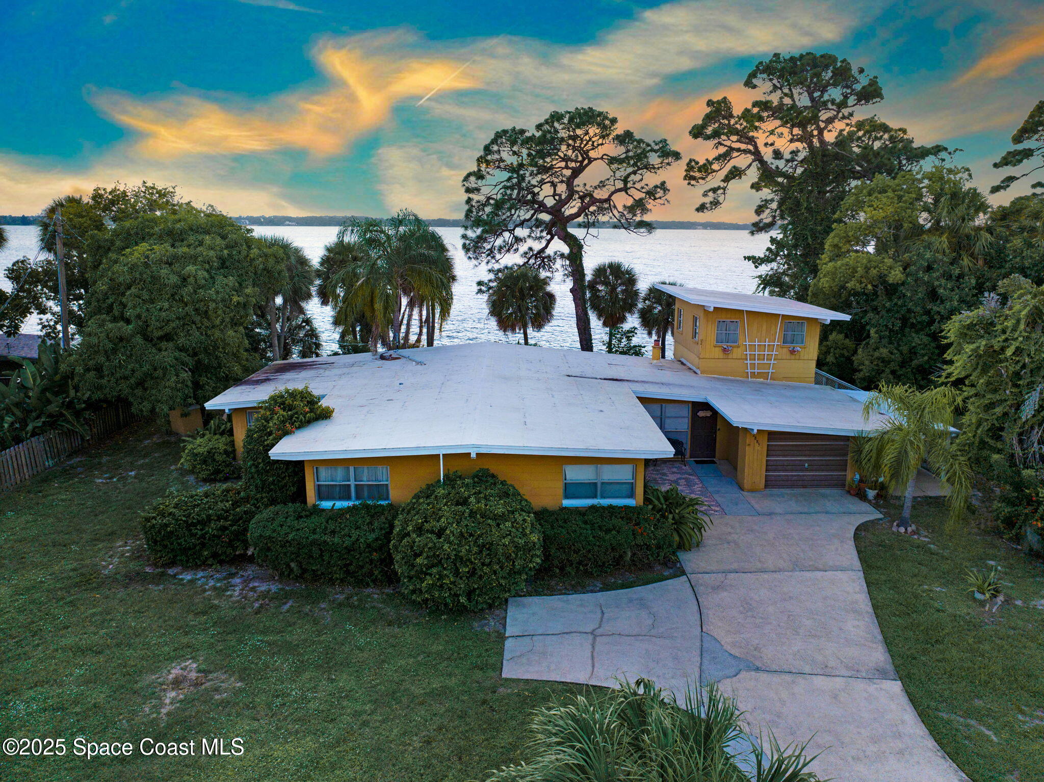a aerial view of a house with a yard and a garage
