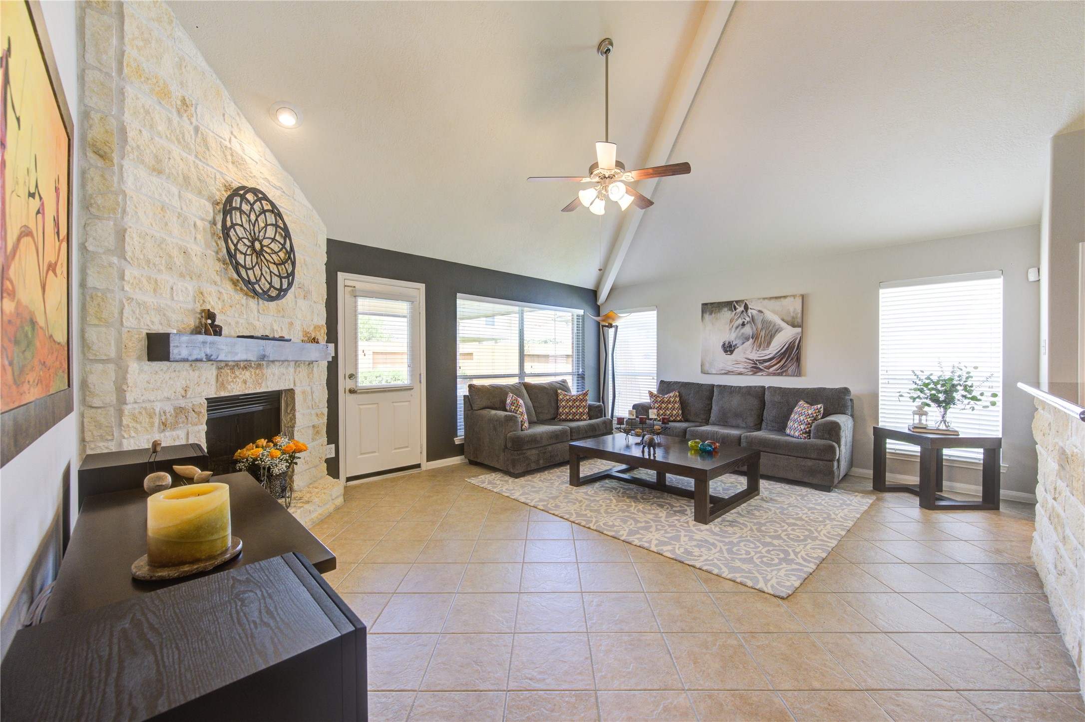 25215 Hazel Ranch Drive Katy, TX 77494 - Photo 15 of 32 a living room with furniture a fireplace and a large window