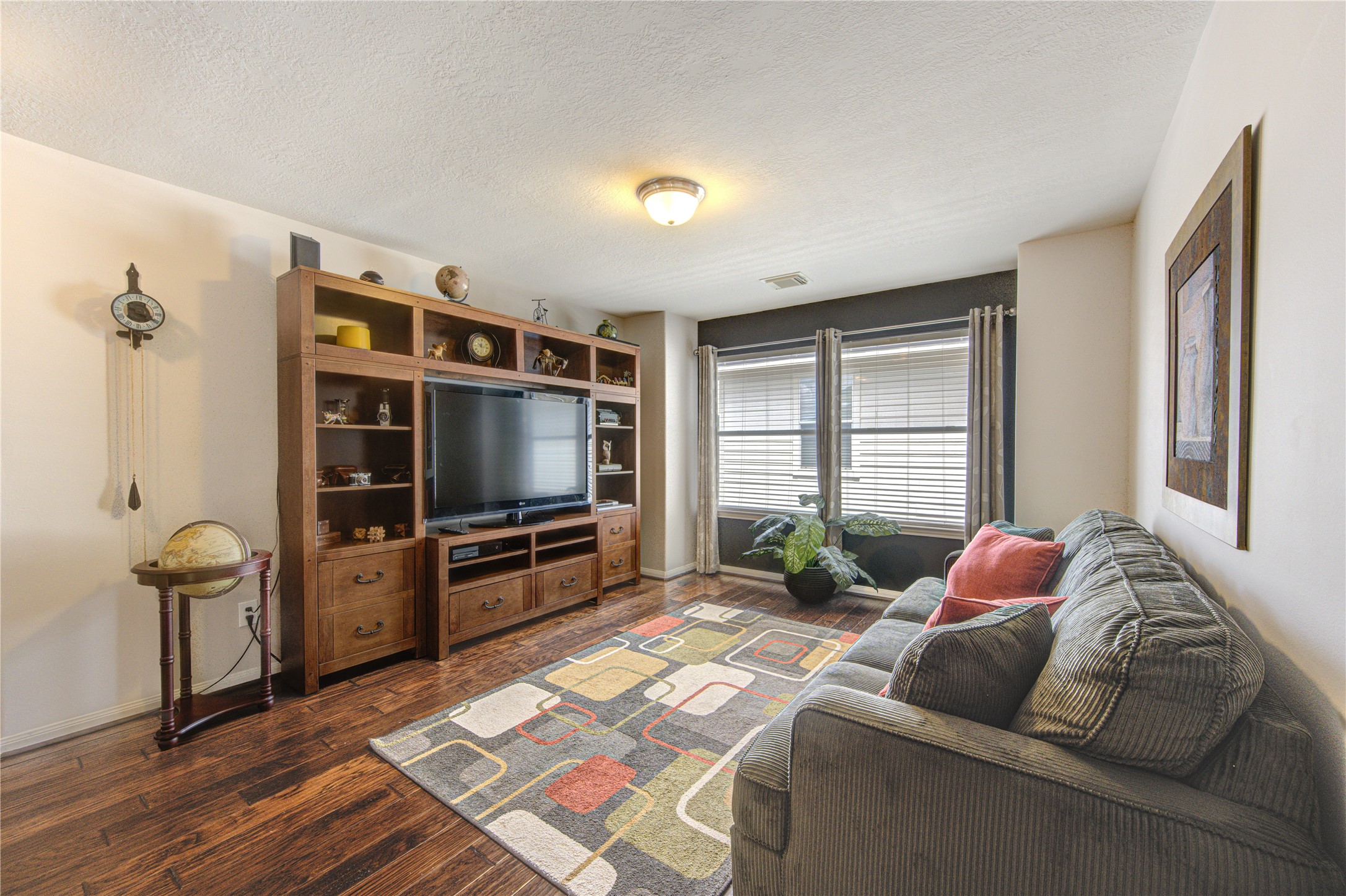 25215 Hazel Ranch Drive Katy, TX 77494 - Photo 22 of 32 a living room with furniture and a flat screen tv