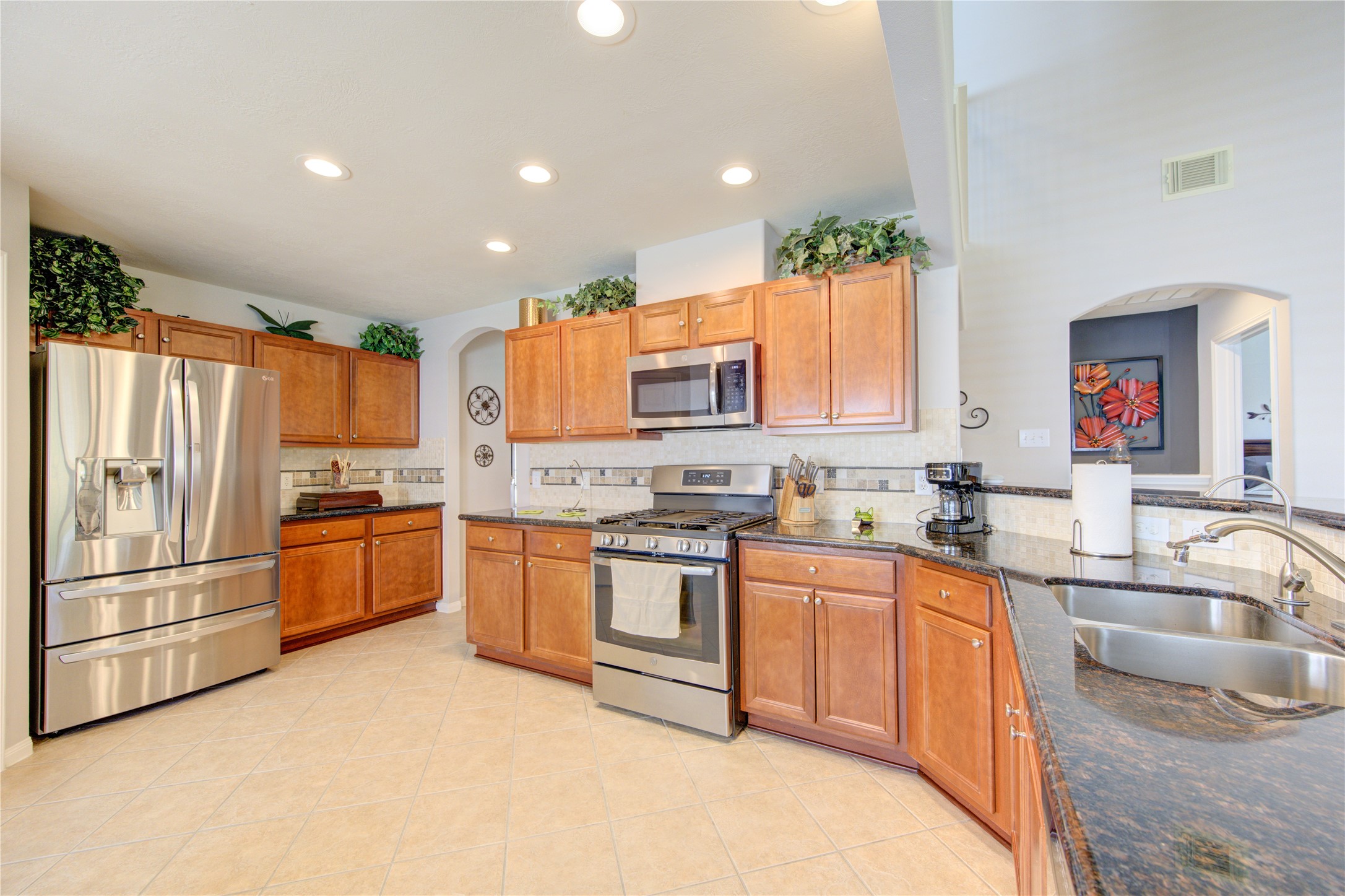 25215 Hazel Ranch Drive Katy, TX 77494 - Photo 9 of 32 a kitchen with stainless steel appliances granite countertop a refrigerator sink and stove