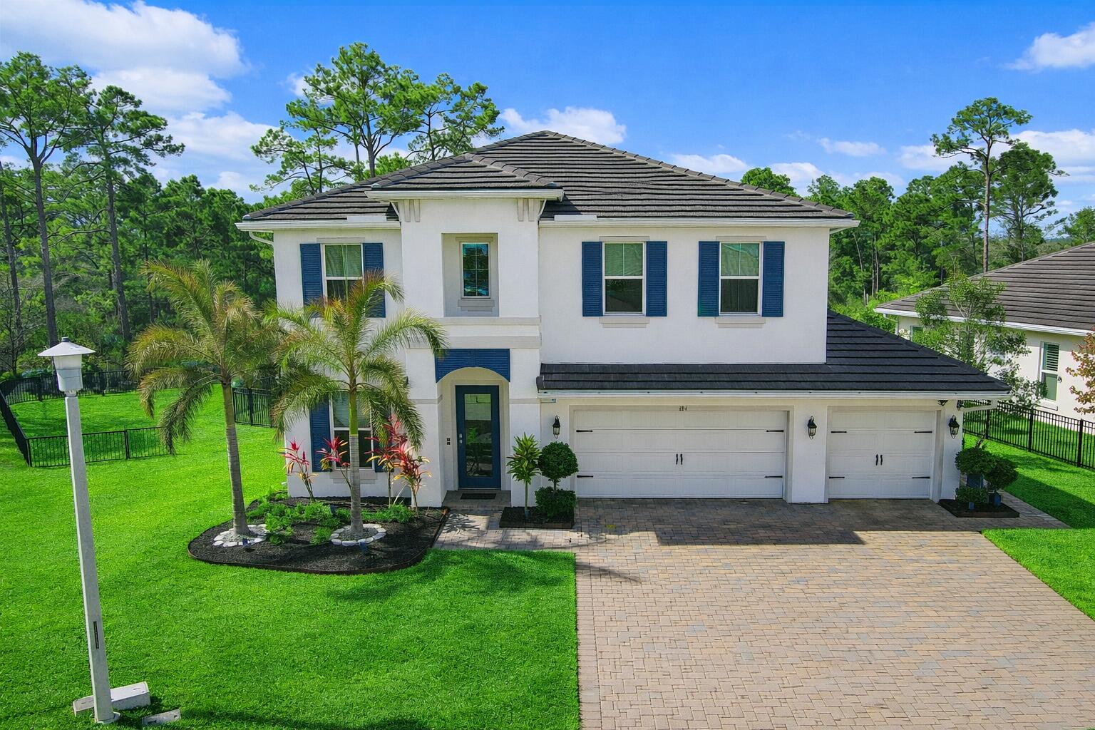 684 Southwest Pennfield Terrace Stuart, FL 34997 - Photo 3 of 61 a front view of a house with a yard