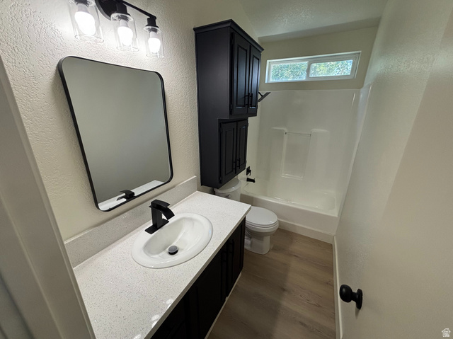 11313 South 265 East Sandy, UT 84070 - Photo 14 of 21 Bathroom featuring a white vanity with an undermount sink, black cabinetry, a black framed mirror, and a black faucet