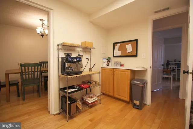 a view of a workspace with furniture and wooden floor