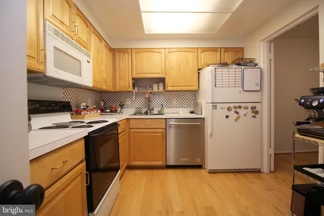 a kitchen with a refrigerator a stove a microwave and cabinets