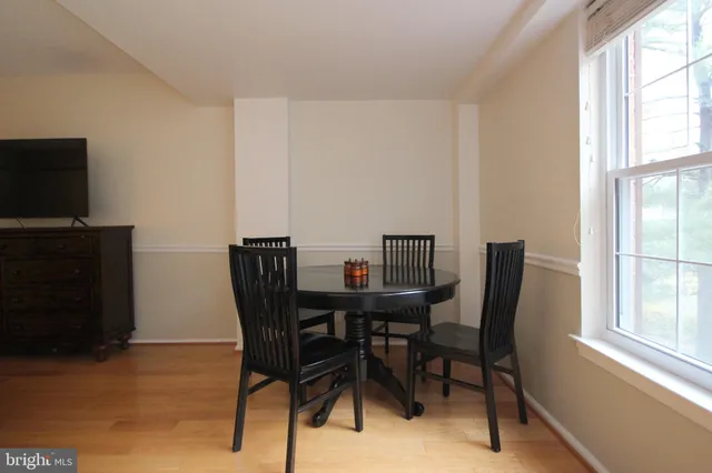 a view of a dining room with furniture and a window