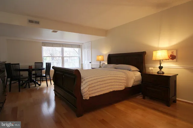 a bedroom with a bed and a table