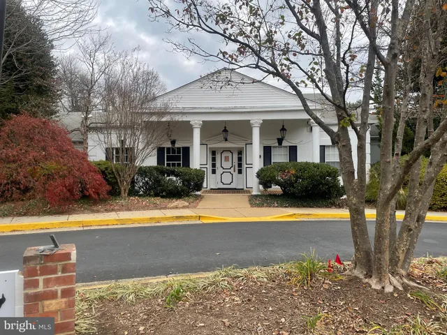 a front view of a house with swimming pool and outdoor seating