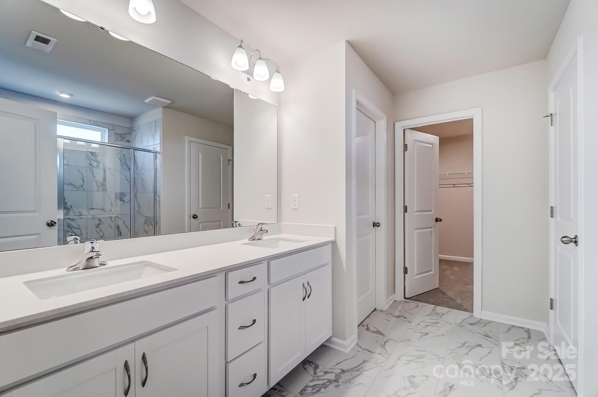 1471 Honey Trail Monroe, NC 28112 - Photo 23 of 27 a spacious bathroom with a double vanity sink mirror and double