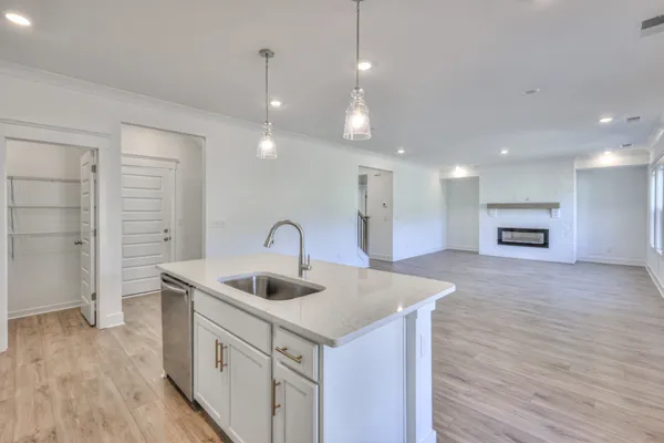 a kitchen with kitchen island a sink stainless steel appliances and windows