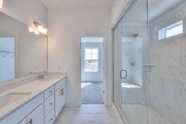 a bathroom with a glass shower door and a bathroom