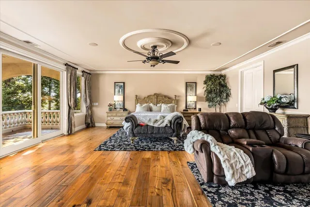 a living room with stainless steel appliances kitchen island granite countertop furniture and a wooden floor