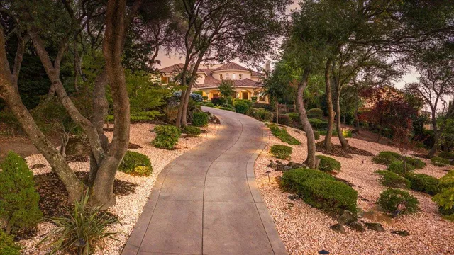 an entrance view of a house with garden