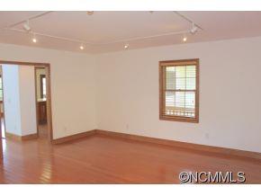 344 Christopher Road Tryon, NC 28782 - Photo 11 of 24 a view of an empty room with wooden floor and a window