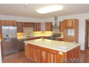 344 Christopher Road Tryon, NC 28782 - Photo 13 of 24 a kitchen with stainless steel appliances granite countertop a sink dishwasher and a refrigerator