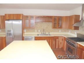 344 Christopher Road Tryon, NC 28782 - Photo 14 of 24 a kitchen with kitchen island granite countertop a sink cabinets and stainless steel appliances