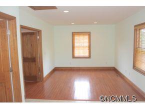 344 Christopher Road Tryon, NC 28782 - Photo 16 of 24 a view of an empty room with wooden floor and a window