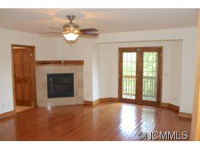 344 Christopher Road Tryon, NC 28782 - Photo 3 of 24 a view of a livingroom with a fireplace and a chandelier fan