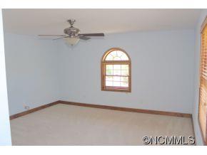 344 Christopher Road Tryon, NC 28782 - Photo 22 of 24 an empty room with a window and a fan