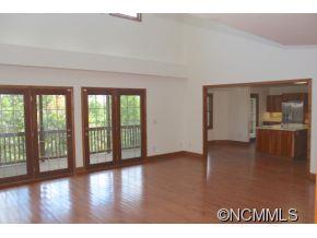 344 Christopher Road Tryon, NC 28782 - Photo 7 of 24 a view of an empty room with wooden floor and a window