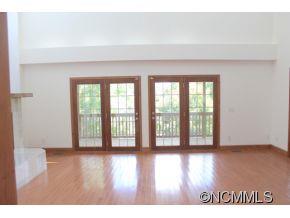 344 Christopher Road Tryon, NC 28782 - Photo 9 of 24 a view of an empty room with wooden floor and a window