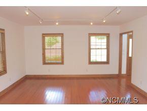 344 Christopher Road Tryon, NC 28782 - Photo 10 of 24 an empty room with wooden floor and windows