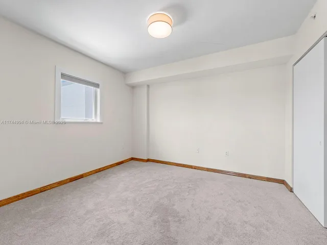 an empty room with a fan