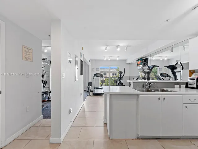 a kitchen with granite countertop a sink and cabinets
