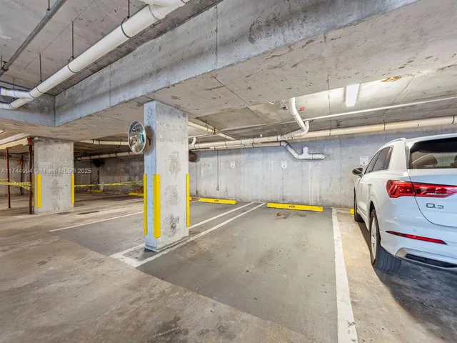 a view of parking garage with cars