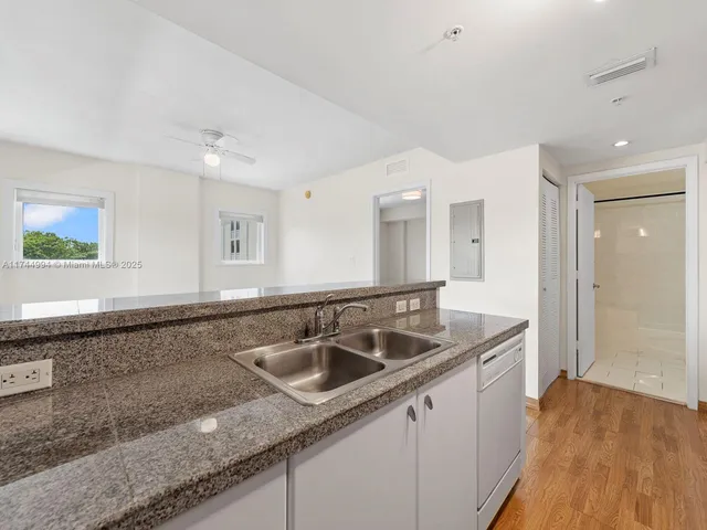 a kitchen with a sink and cabinets