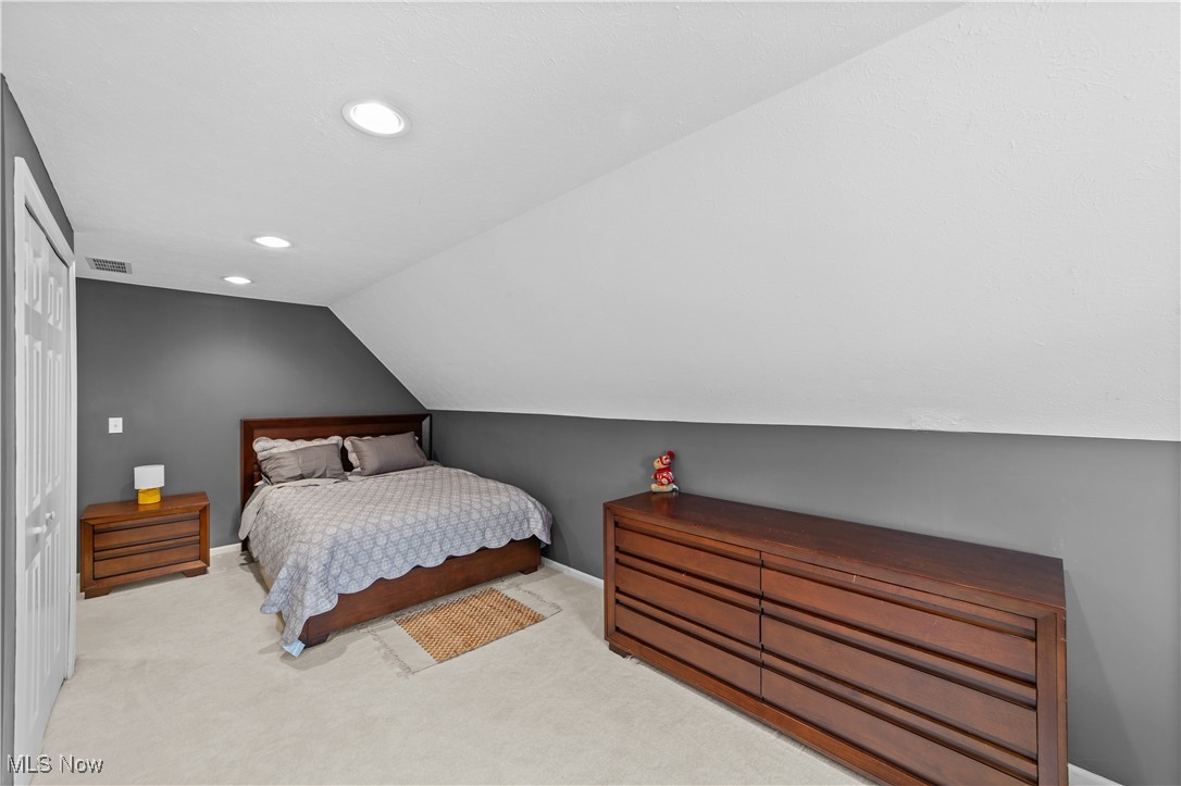 30825 Cannon Road Solon, OH 44139 - Photo 32 of 49 Carpeted bedroom with lofted ceiling, a closet, and recessed lighting