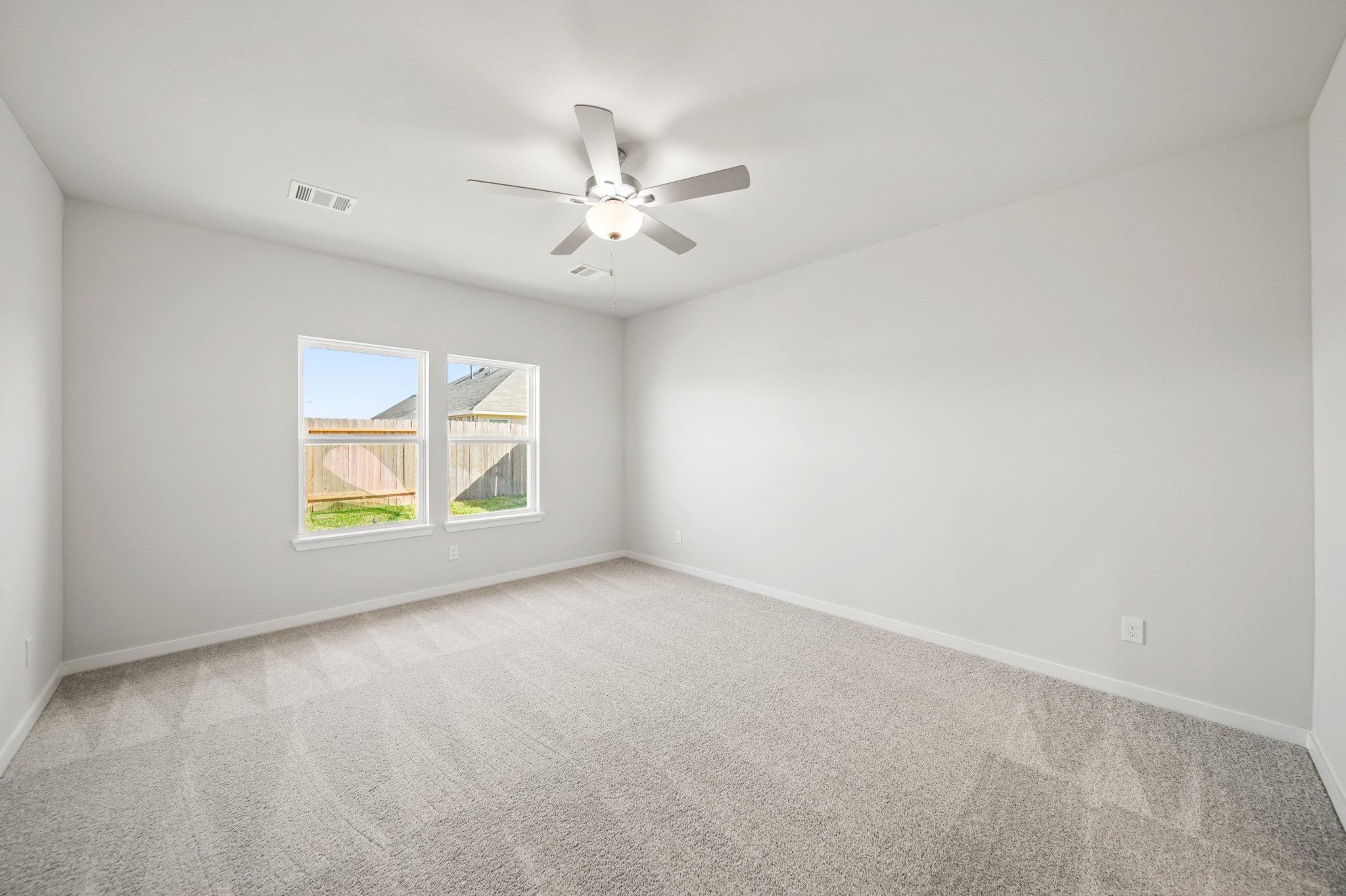 314 Bennett Street Angleton, TX 77515 - Photo 12 of 27 an empty room with windows and fan